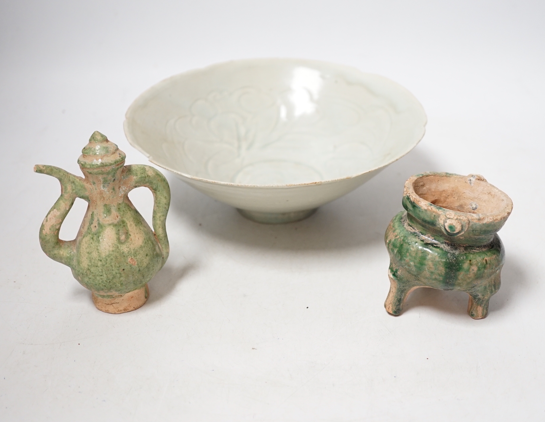 A Chinese incised Qingbai bowl, Song Dynasty and two green glazed Ming Dynasty pottery models of vessels, bowl 20cm diameter